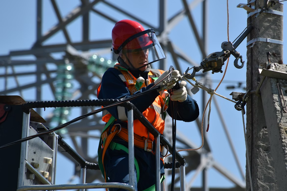 Technicien en électricité au travail sur un réseau de distribution